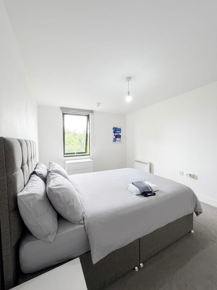 Guest bedroom with white bedding and folded towels