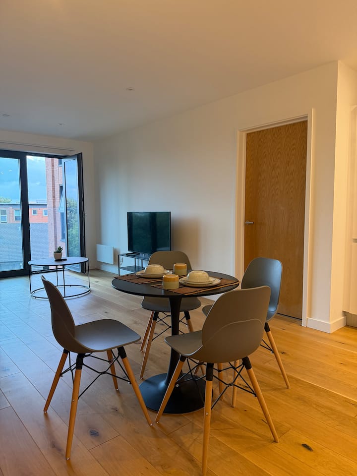 Apartment dining area opening into a living room